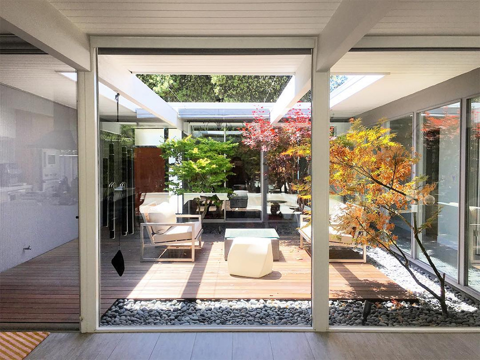 Glass wall with view of courtyard atrium with chairs