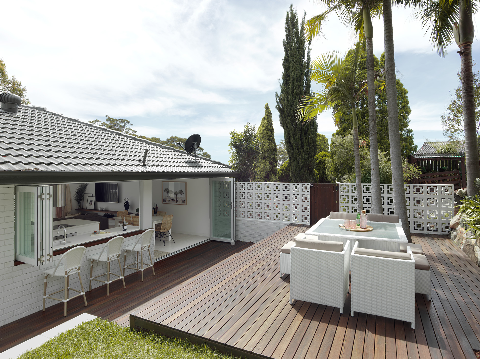 Back yard of ranch home with service window & privacy screen