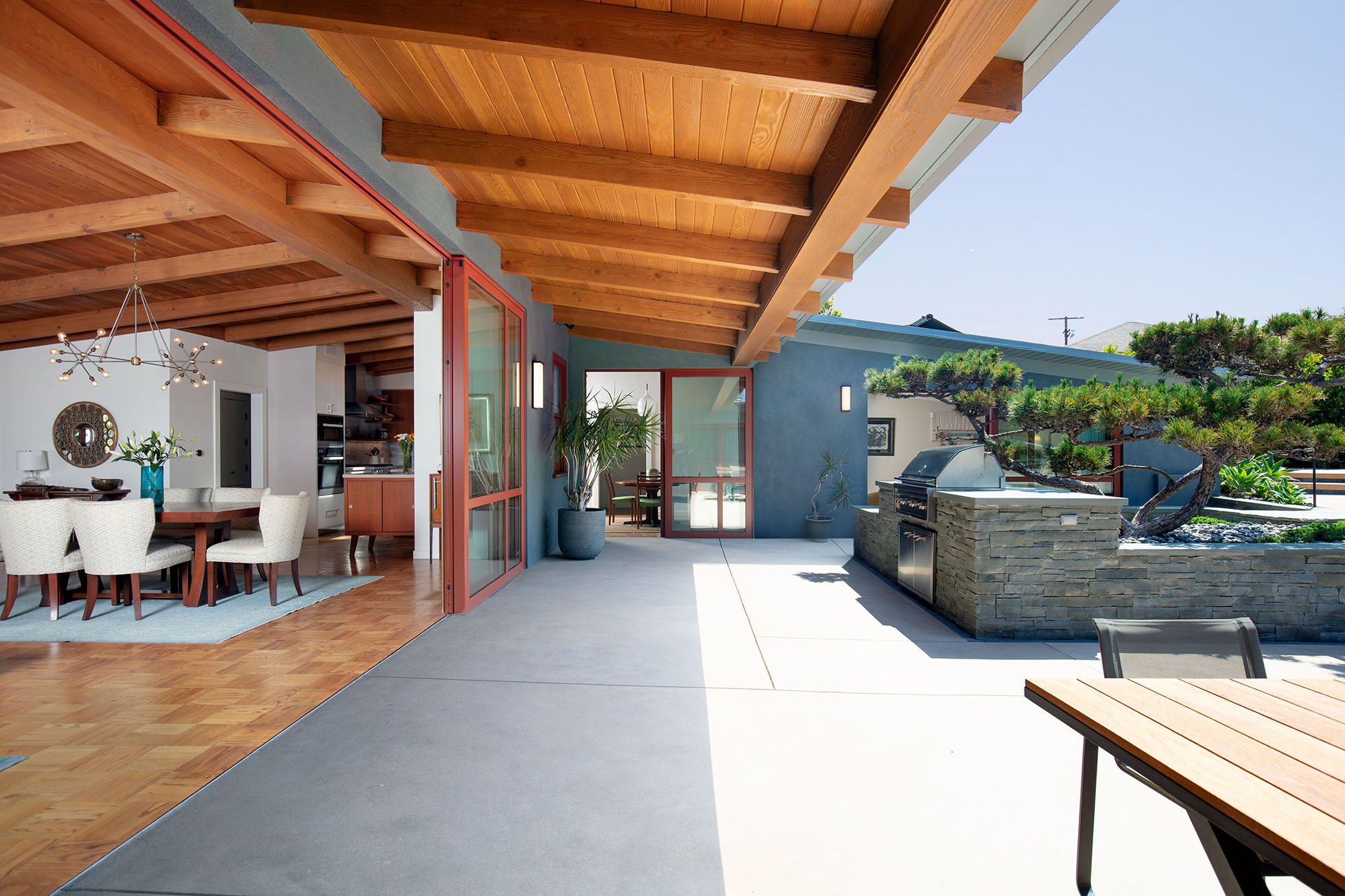 Outdoor entertaining area with sliding door and kitchen