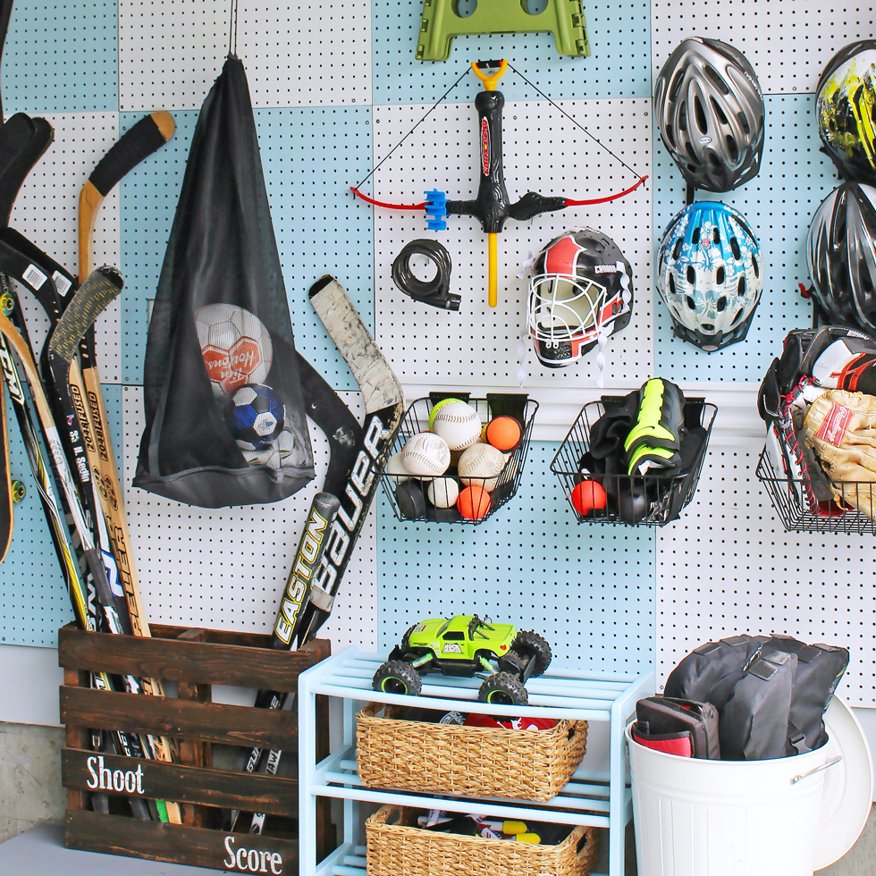 White and blue pegboard in a garage with sports equipment