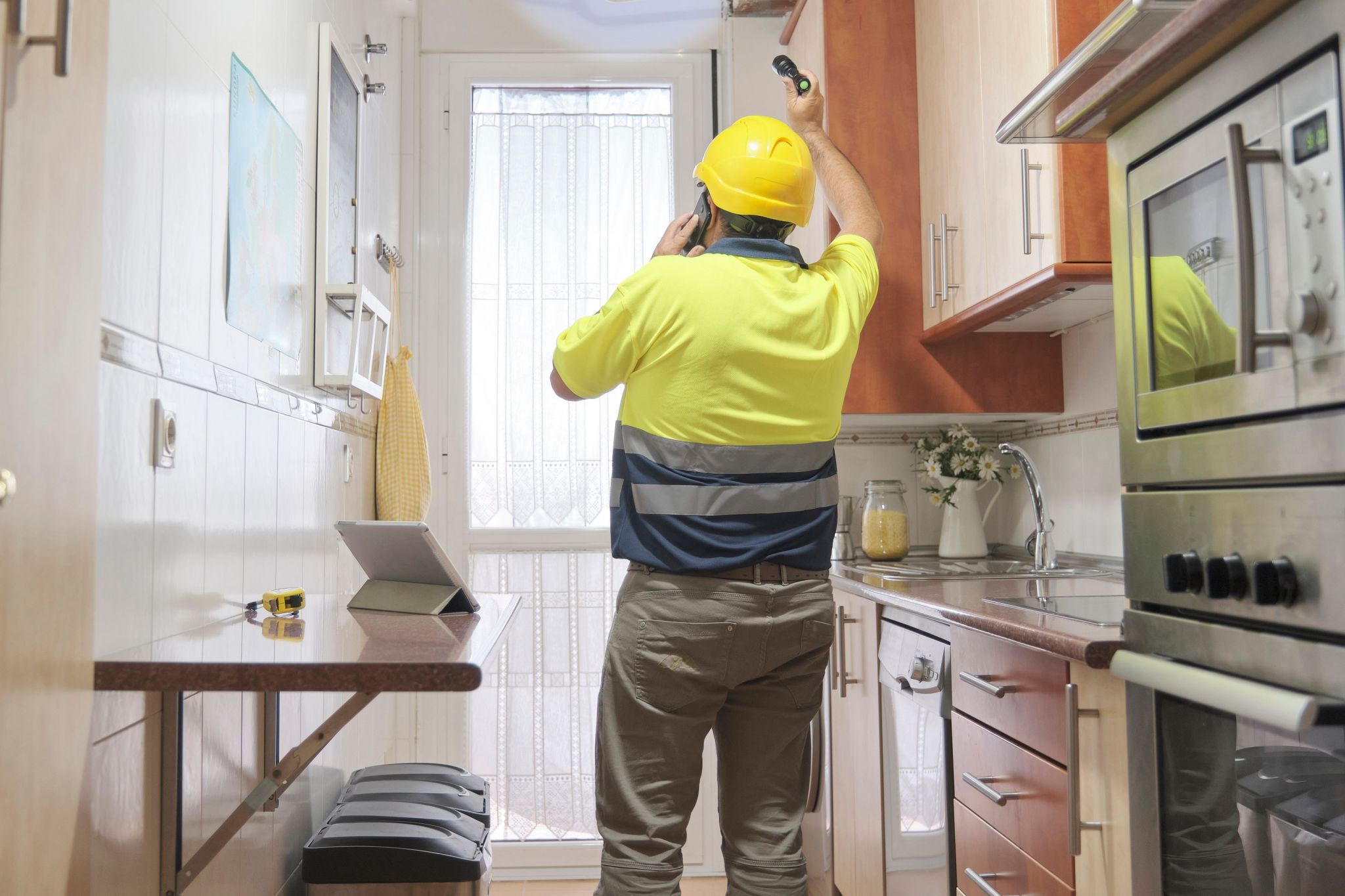 Someone inspecting part of a house in an example of a prelisting home inspection sellers could consider.