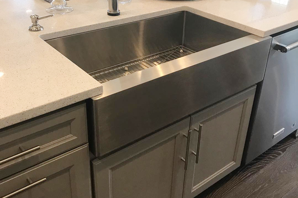 A close-up of a deep stainless sink in a kitchen