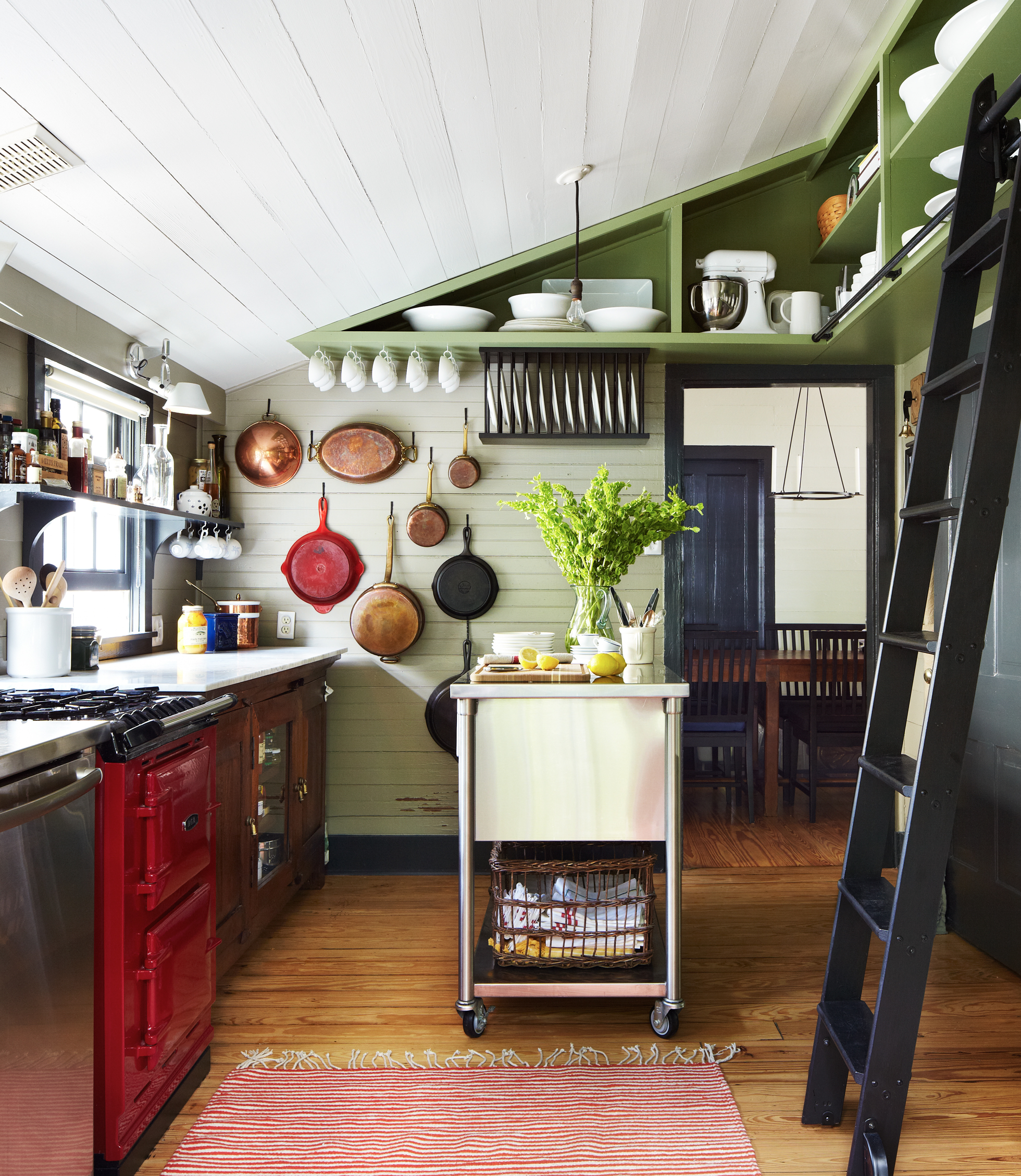 Green open shelving in a bright kitchen