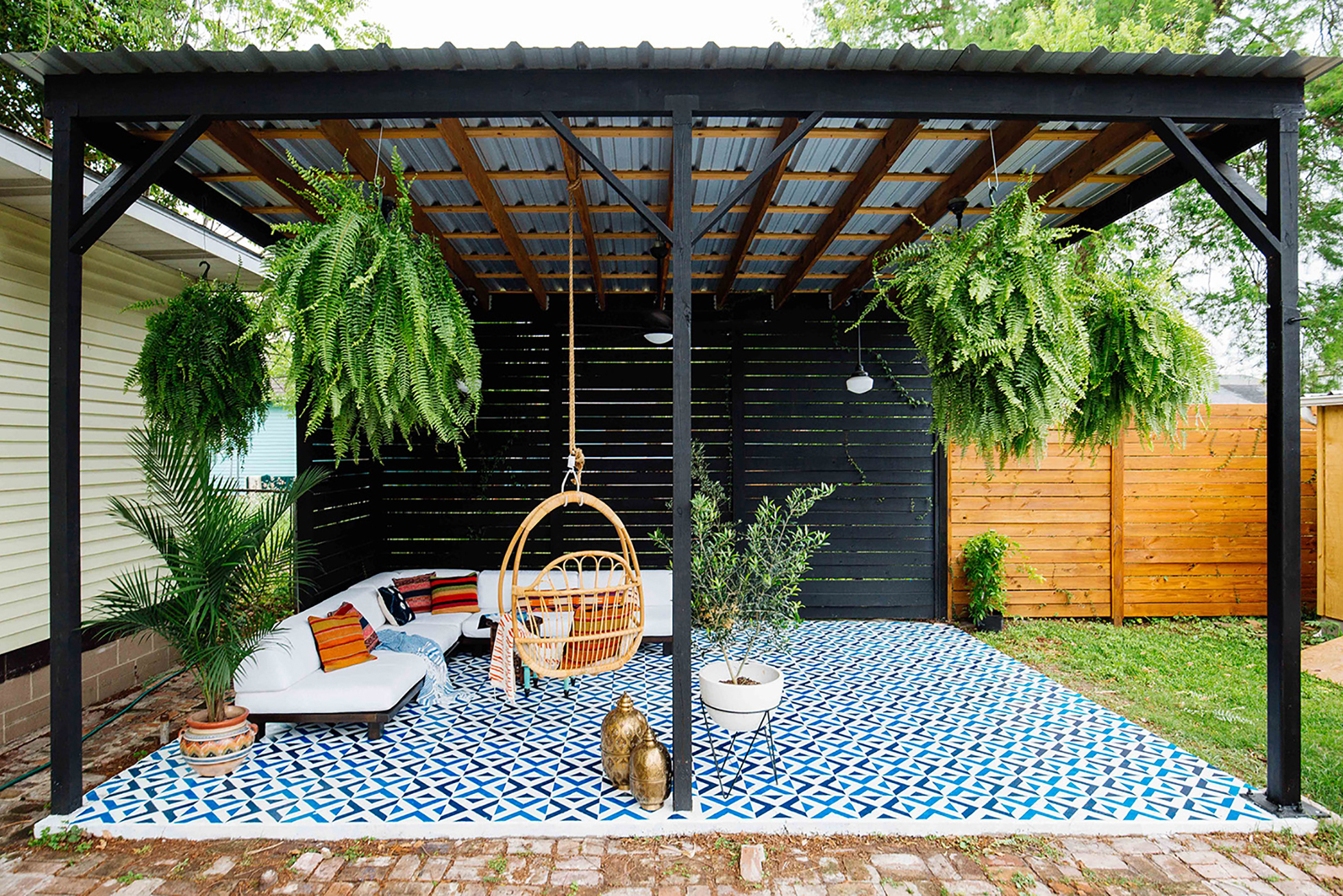 A covered patio with painted concrete floor