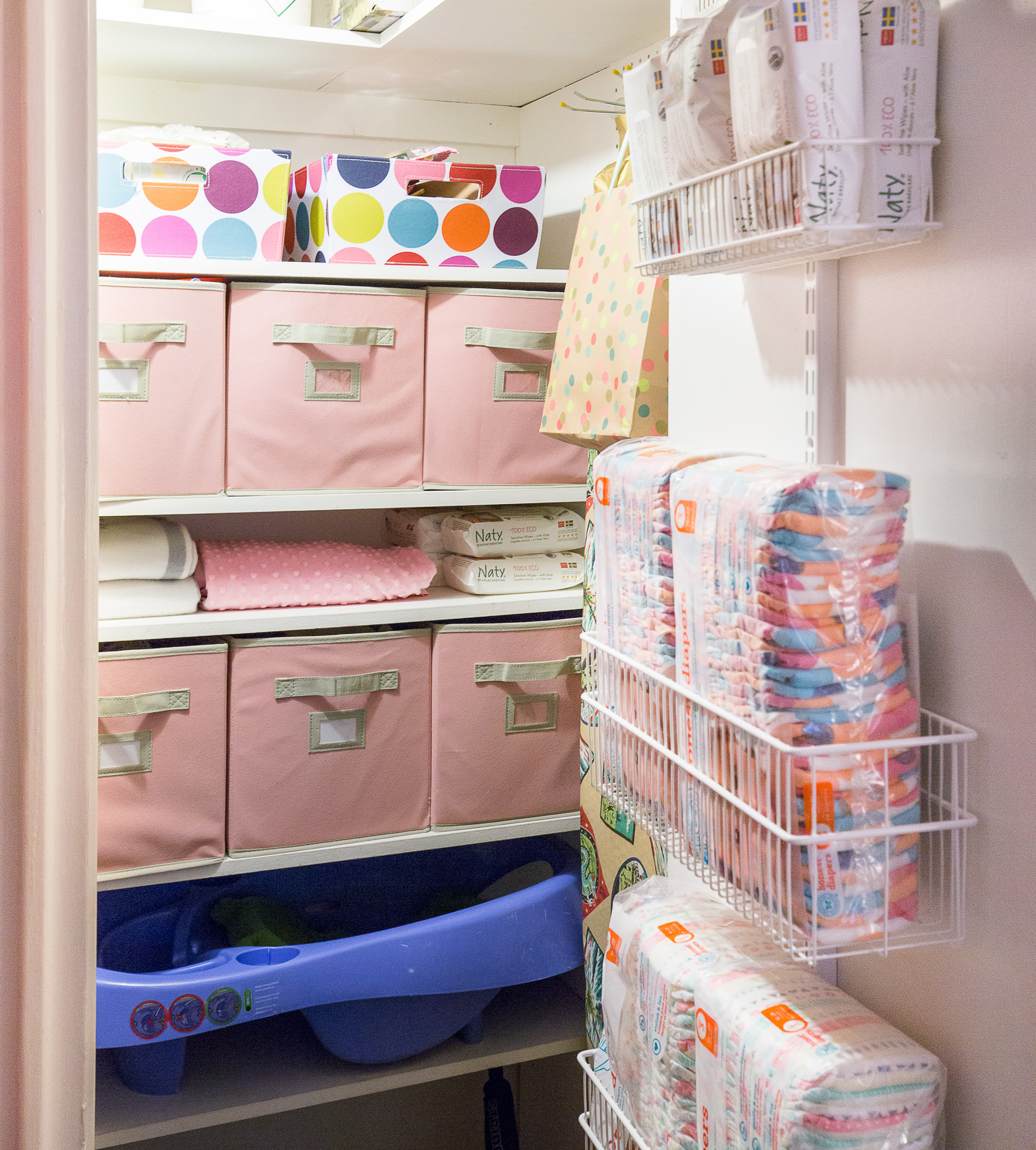 Toys are stored in fabric boxes in this children's closet