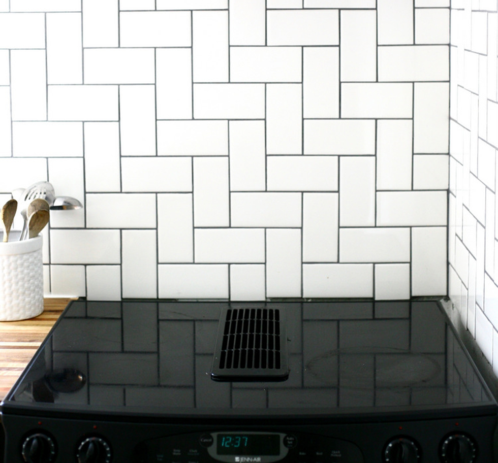 Stacked herringbone tile backsplash in a kitchen