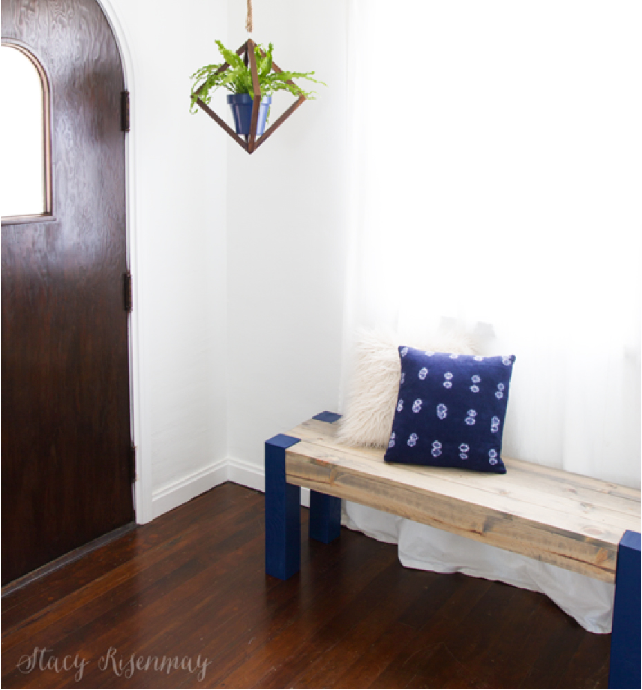White entryway with hanging plant and DIY wood bench