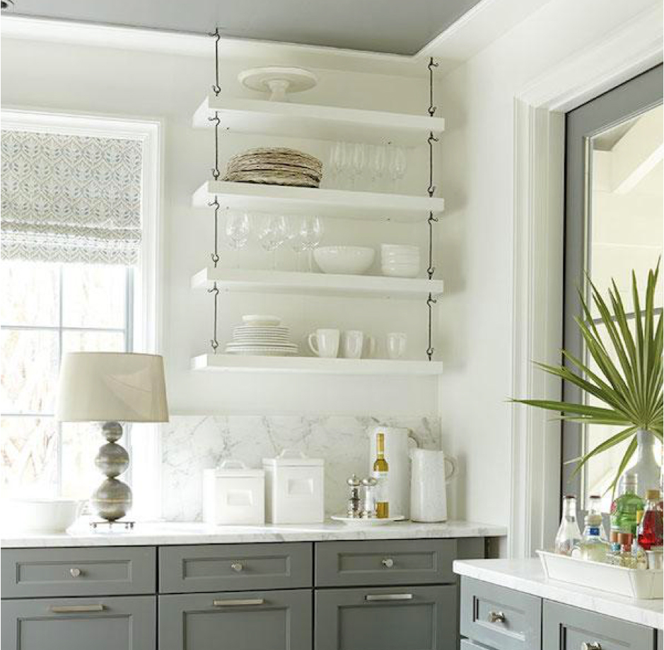 White kitchen with white open shelving with white dishes