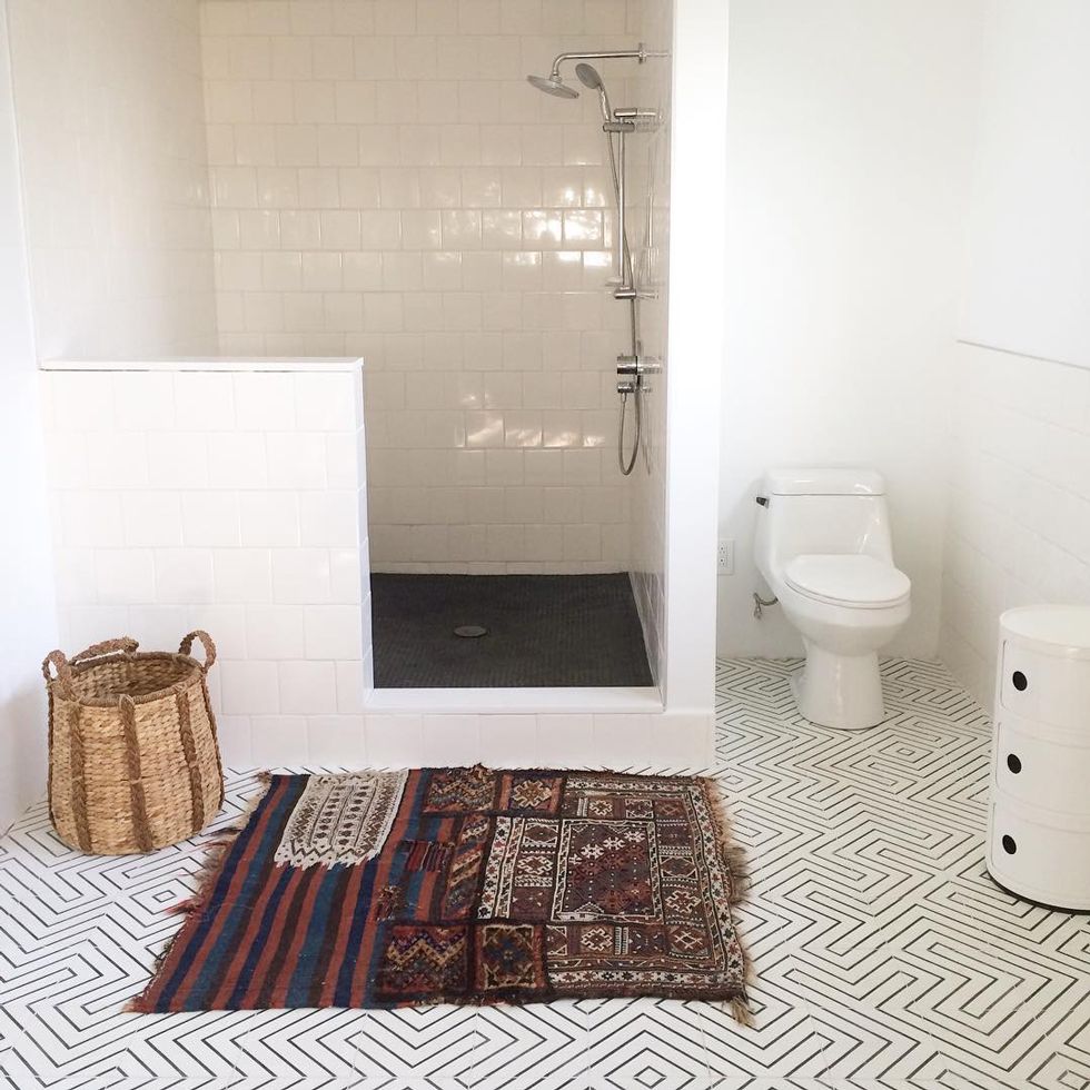 A white tile bathroom with walk-in shower
