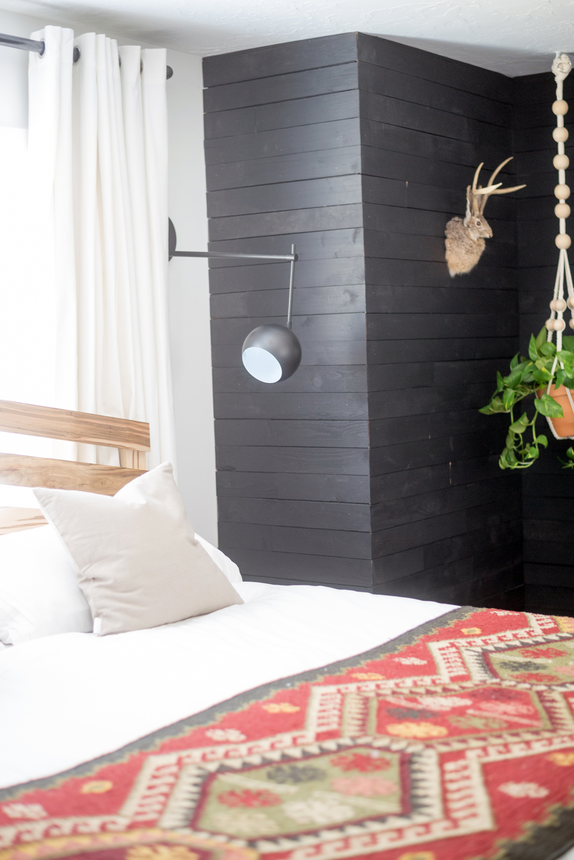 Black accent wall in a bedroom
