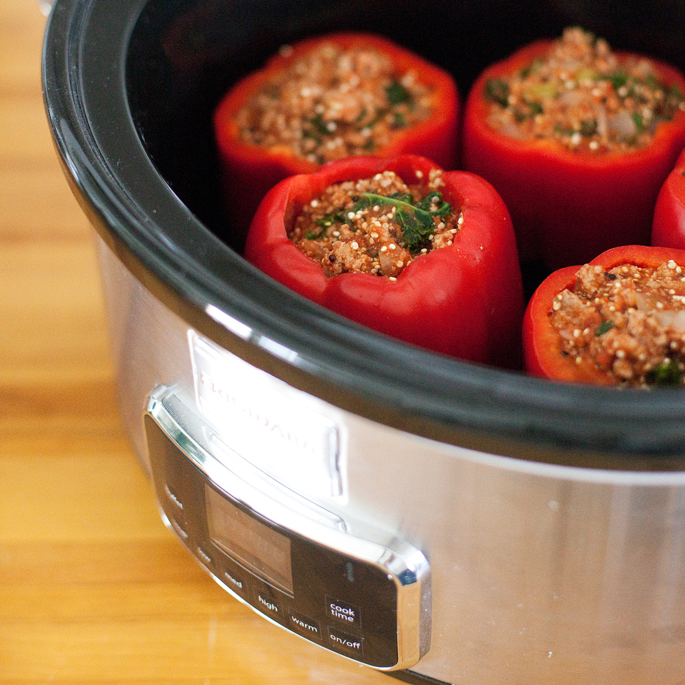 Red peppers in a slow cooker on a kitchen countertop
