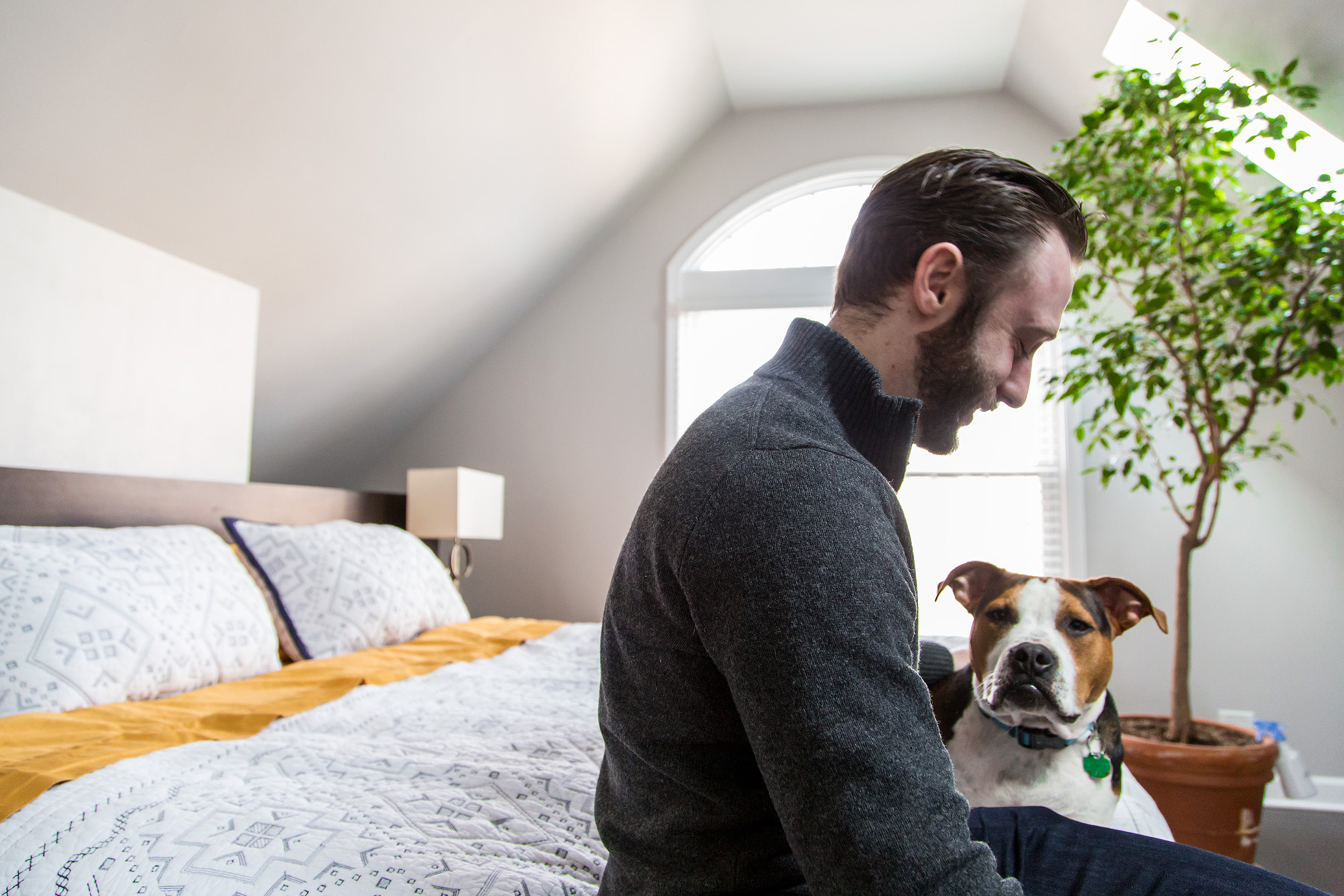 Grigory Pekarsky in his bedroom with his dog