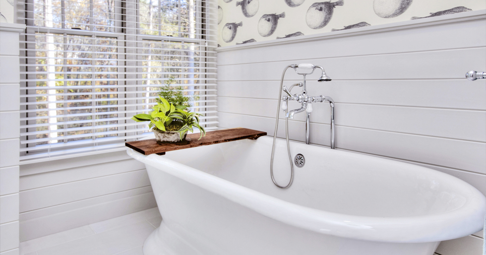 A white cast iron tub in a white bathroom