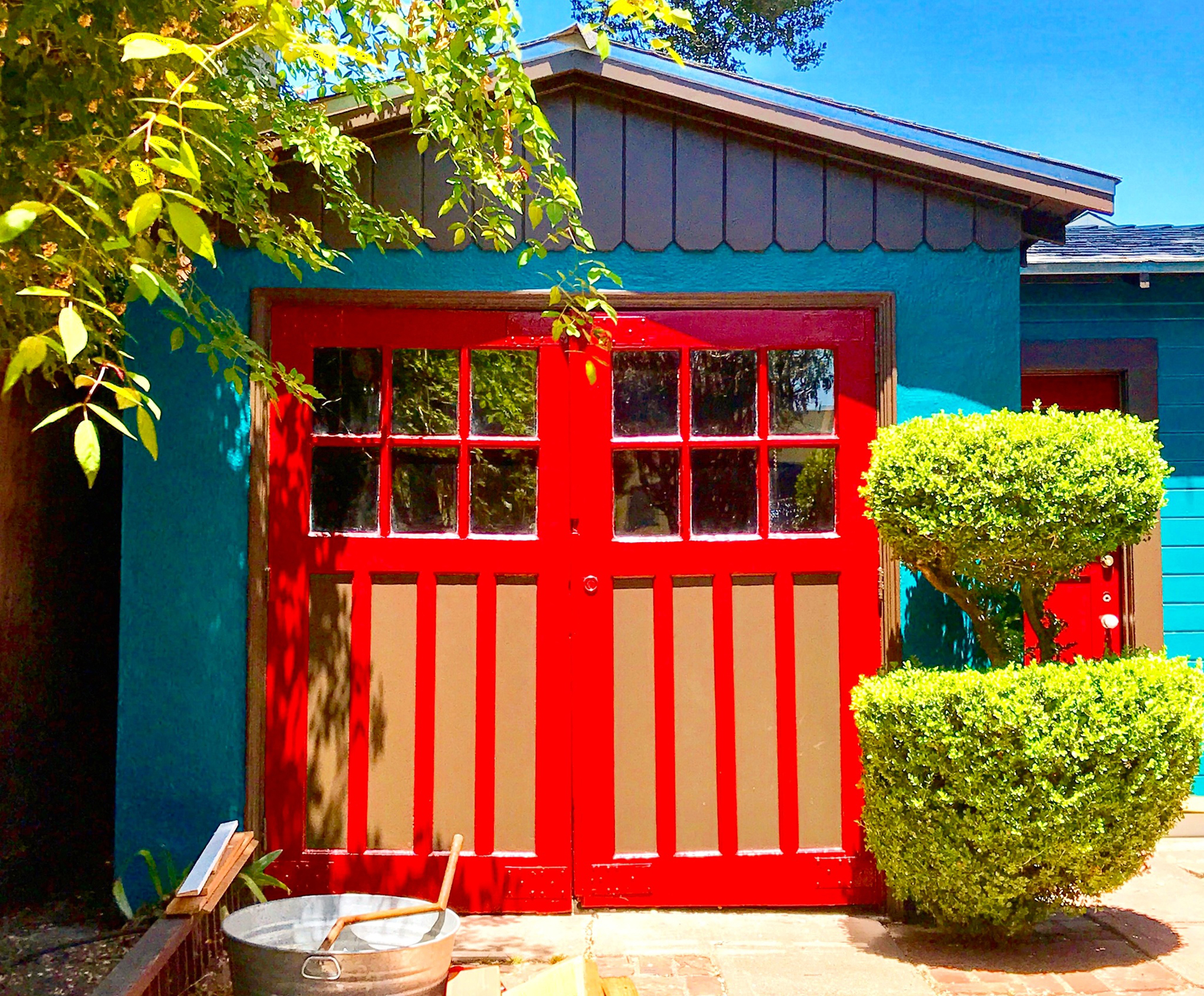 Blue and red painted detached garage