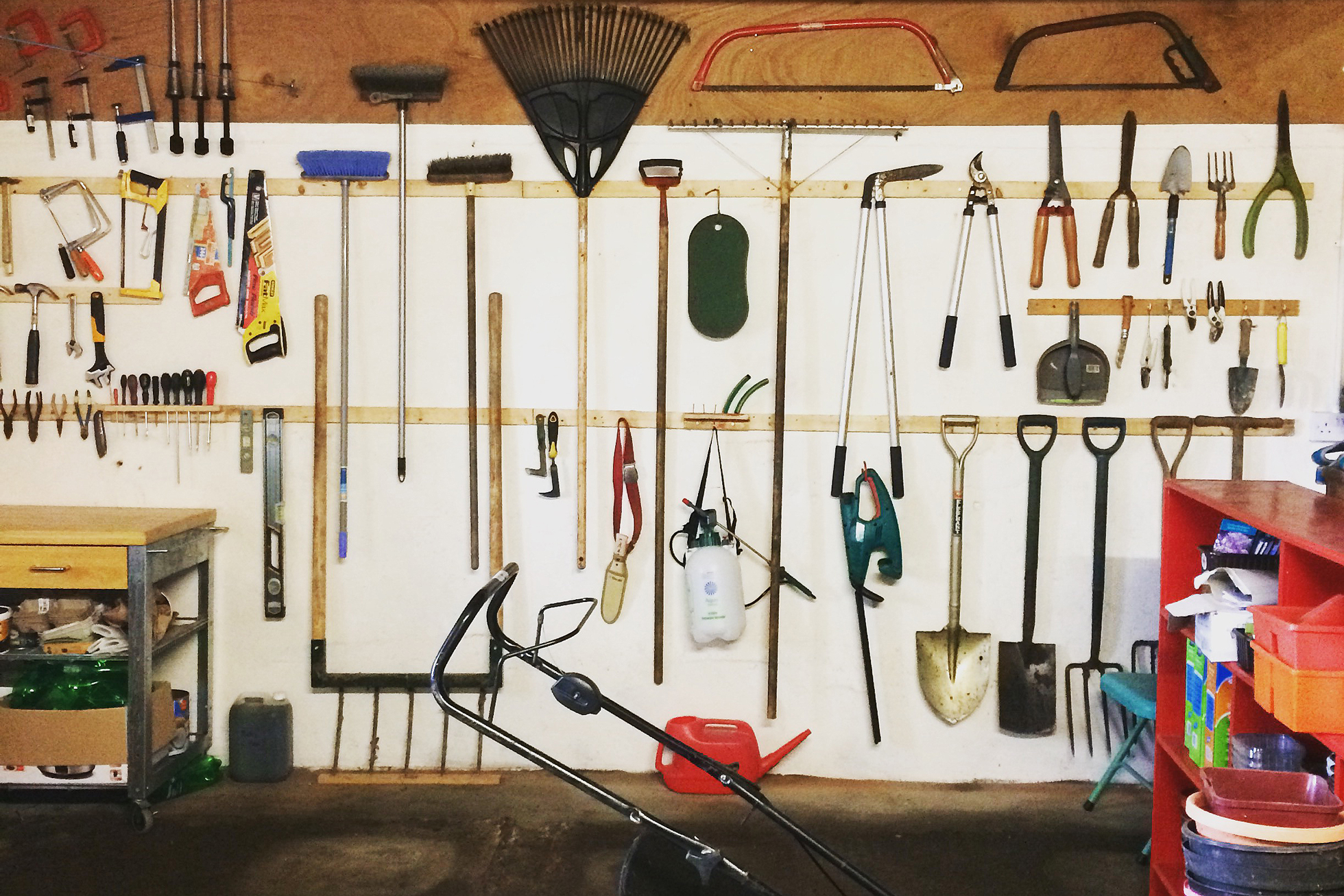 Lawn tools hanging in a garage