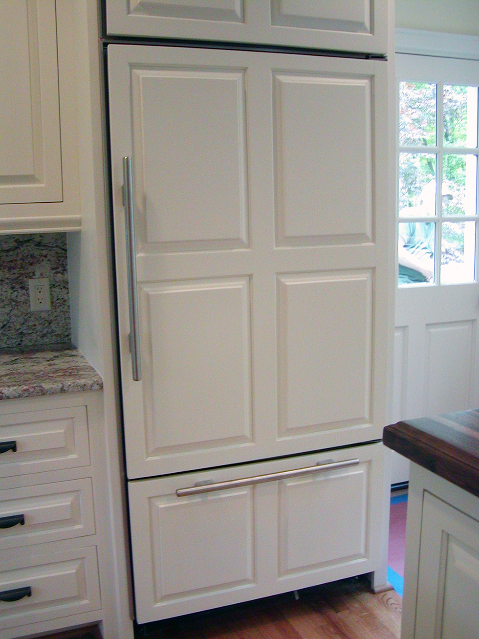 Refrigerator concealed by custom panel