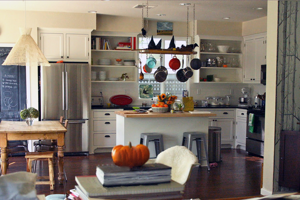 Dark wood floor in white kitchen