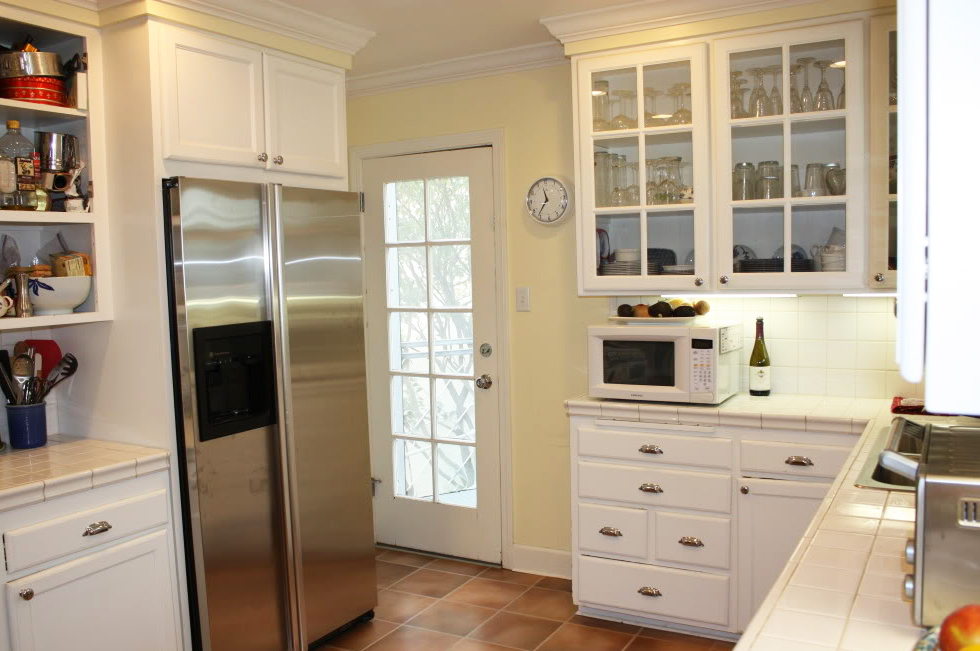 Glass front upper cabinets in white kitchen