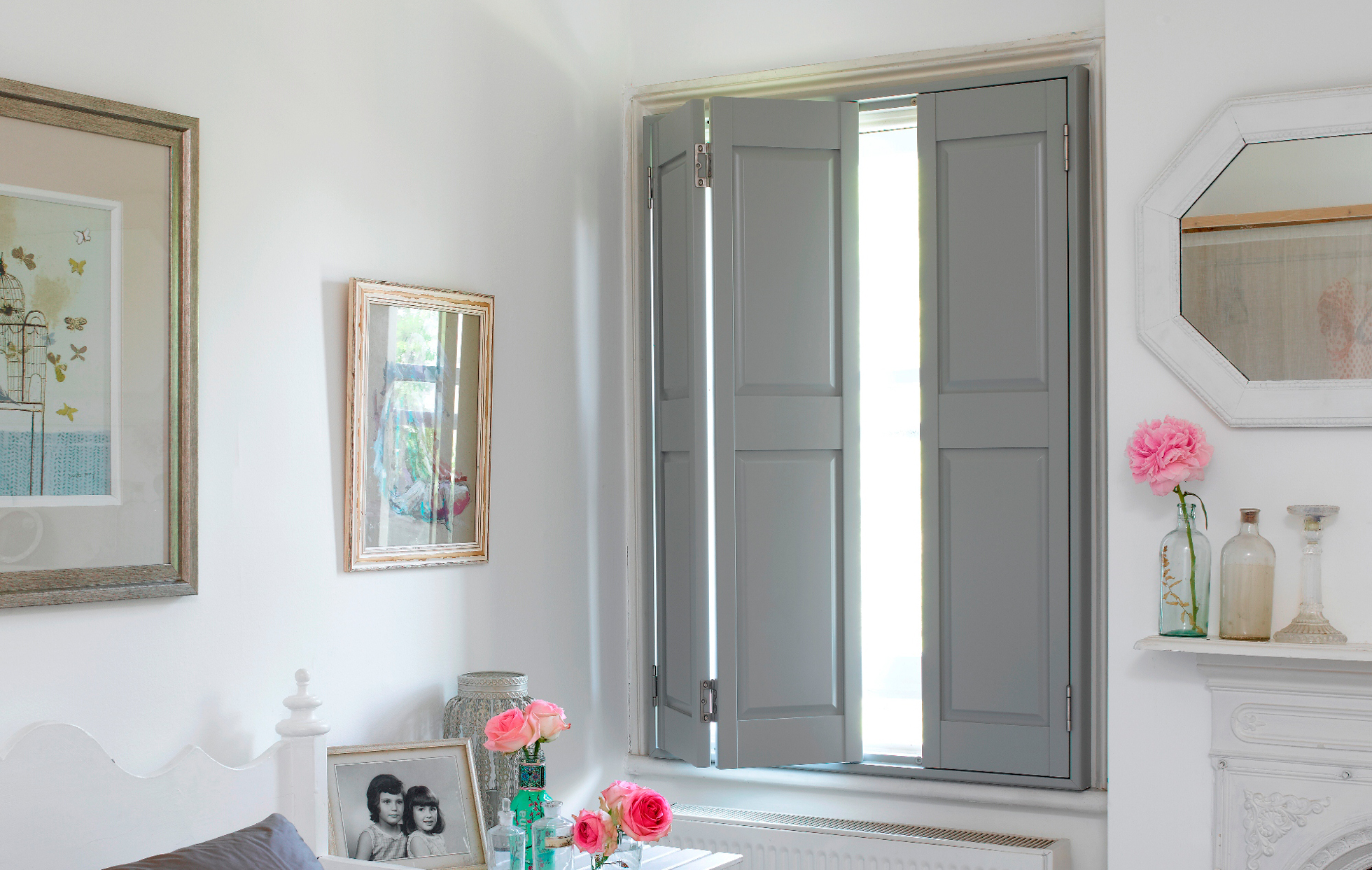 Solid gray interior shutters in a bedroom