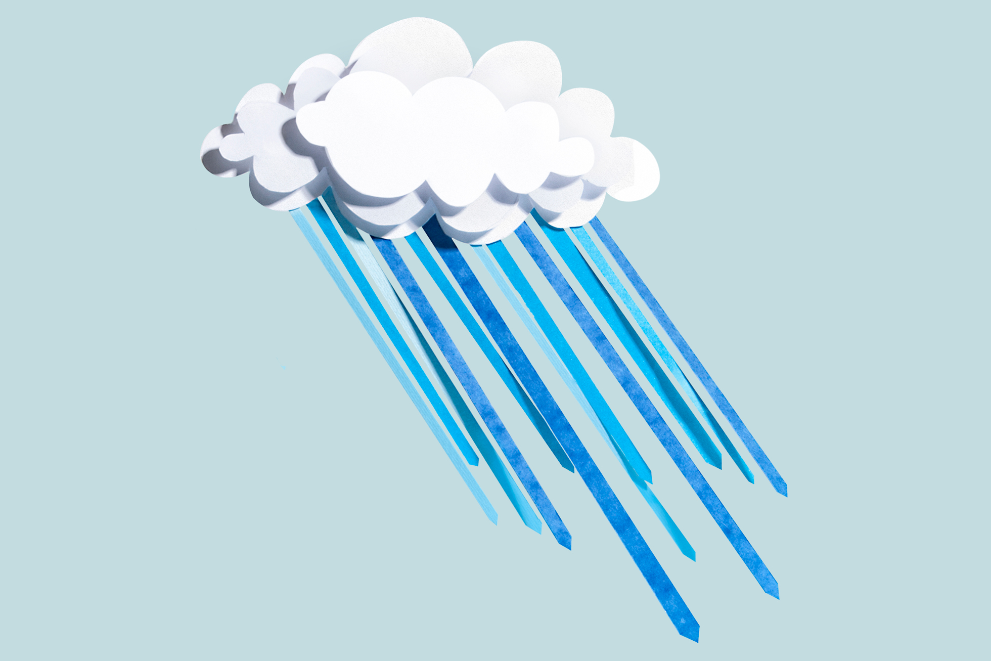 A light blue background with a paper-cut cloud and rain